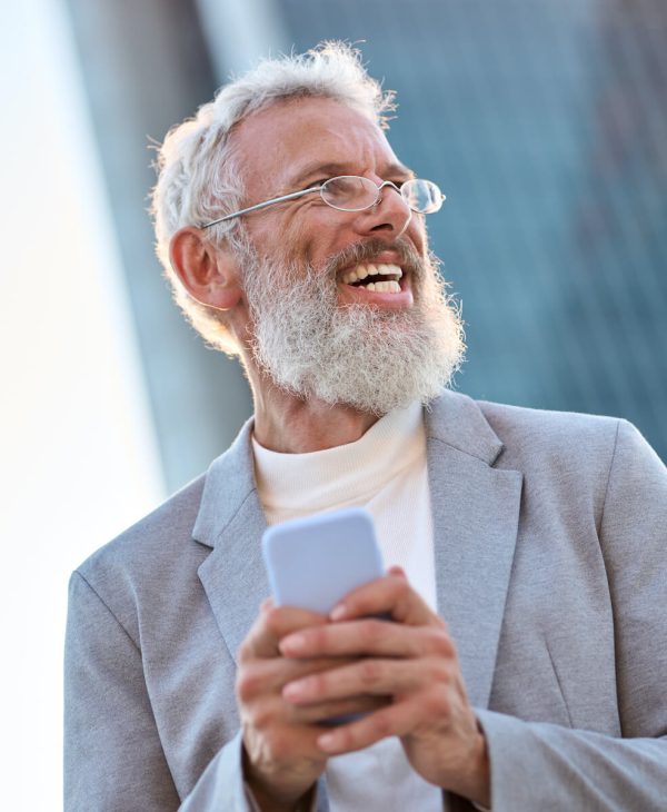 happy-old-professional-business-man-holding-phone-2023-11-27-05-12-40-utc.jpg